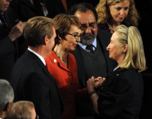 Gabrielle Giffords (in red) is greeted by Secretary of State Hillary Clinton in 2012