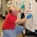 A Winnebago employee puts finishing touches on another RV