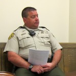 A Cerro Gordo County Sheriff's Deputy sits in the back of the room at a Supervisor's meeting, at the request of Jay Urdahl.