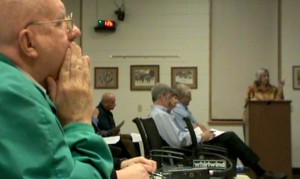 John Skipper of the Globe Gazette motions to the Mayor and City Council as Mason City citizen Cheryl Gerk speaks in 2012.  Skipper ws overheard mumbling and making other gestures to Mayor Eric Bookmeyer as Ms. Gerk spoke.