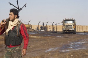 A Syrian rebel stands guard at an oil well near Shahel, Syria, November 20, 2012. 