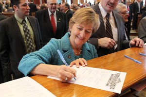 Sharon Steckman signs papers at the State Capitol in Des Moines on Monday, January 14th, 2013.