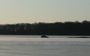 A Volkswagen Passat partially submerged on ice at Clear Lake.
