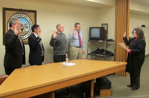 Judge Colleen Weiland, far right, swears in elected officials Tuesday morning.