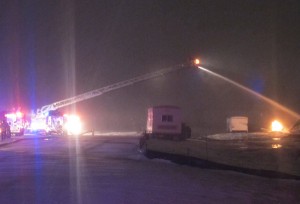 MCFD battles a blaze at a construction site as heavy snow falls Friday morning.