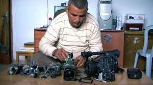 Film maker Emad Burnat with his broken cameras