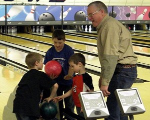 Jackson (in Red) gets tips on Bowling from brothers Shawn and Alex