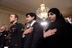 Foreign nationals place their hands on the chests during the National Anthem during a naturalization ceremony in the East Room at the White House on March 25, 2013 in Washington, D.C.  Obama attended the ceremony where Homeland Security Director Janet Napolitano naturalized 28 foreign citizens.  UPI/Kevin Dietsch