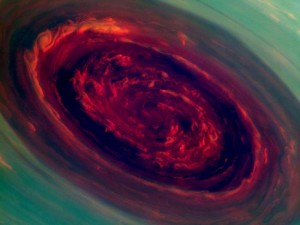 The spinning vortex of Saturn's north polar storm resembles a deep red rose of giant proportions surrounded by green foliage in this false-color image from NASA's Cassini spacecraft. Measurements have sized the eye at a staggering 1,250 miles (2,000 kilometers) across with cloud speeds as fast as 330 miles per hour (150 meters per second). 
