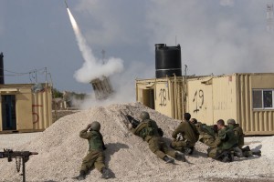 Israeli soldiers take cover as they fire an Iron Dome intercept rocket in southern Israel. UPI/Mati Milstein