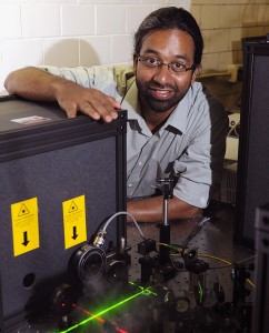 Sanjeevi Sivasankar of Iowa State and the Ames Laboratory has developed special instruments to study cell adhesion. Larger photo. Photo by Bob Elbert.