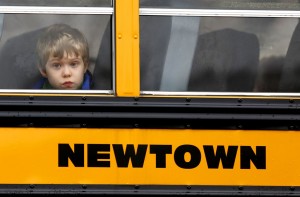 A boy looks out at the funeral of James Mattioli in Saint Rose of Lima Church in Newtown, Connecticut following a shooting four days before that left 26 people dead including 20 children on December 18, 2012. A gunman opened fire inside Sandy Hook Elementary School early Friday morning. The gunman 20-year-old Adam Lanza killed himself following the shooting rampage inside the school.     UPI/John Angelillo
