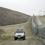 A United States Border Patrol vehicle cruises along the primary and secondary fence line on the Tijuana, Mexico border in San Diego. (UPI Photo/Earl Cryer)