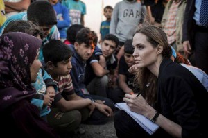 UNHCR Special Envoy Angelina Jolie (right) records the stories of refugees who have just escaped the war in Syria at the Jaber border crossing in Jordan on 18 June 2013. Photo: UNHCR/O. Laban-Mattei