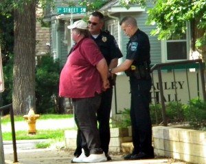 Bruce Simpson being handcuffed