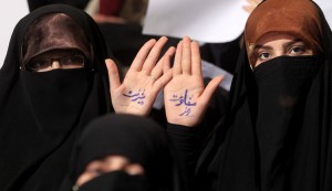 Supporters of presidential candidate Saeed Jalili  show their hands with  "improvement" (L) and "secret of resistance" (R) written in Farsi, during a campaign rally at Tehran University in Tehran, Iran on June 3, 2013. Iran's presidential election will be held on June 14, 2013.     UPI/Maryam Rahmanian