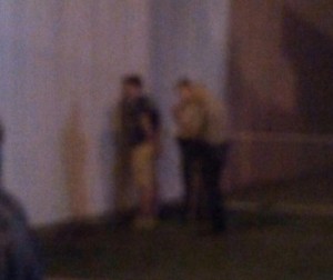 The young man is cuffed, presumably for an alcohol violation.  Photo from NIT associate.