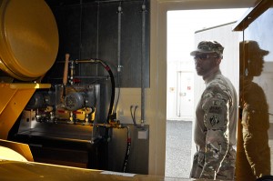 Chief Warrant Officer 4 Keith Wright, deputy commander of a power production task force with USACE Transatlantic Afghanistan district, inspects a generator on a small base in Kandahar, Afghanistan. 