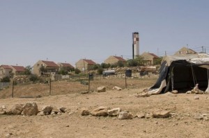 An Israeli settlement viewed from the Um-al-Kher bedouin community in the West Bank. Photo: OCHA 