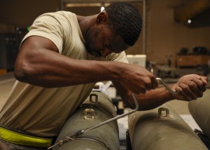 Staff Sgt. Everett Myles uses a speed handle to secure straps on a laser joint directed attack munition during a bomb build at the 379th Air Expeditionary Wing in Southwest Asia, Sept. 2, 2013. Myles is a 379th Expeditionary Maintenance Squadron conventional maintenance crew chief deployed from Dyess Air Force Base, Texas, and hails from Fort Worth, Texas. (U.S. Air Force photo/Senior Airman Bahja J. Jones)