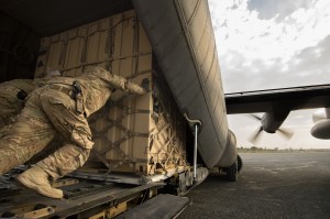 Staff Sgt. Daniel Hall, along with other 19th Movement Control Team aerial porters muscle a "tricon" shipping container into a 774th Expeditionary Airlift Squadron C-130 Hercules cargo plane at Forward Operating Base Salerno, Khost province, Afghanistan, Sept. 22, 2013. The 19th MCT, a small squadron of Air Force surface movement controllers and aerial porters, have the herculean task of overseeing the vast majority of retrograde operations at FOB Salerno. Hall, a Smith Valley, Nev. native is forward deployed from Travis Air Force Base, Calif.  