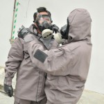 During an OPCW training course on emergency response to chemical incidents, participants learn to use protective gear. Photo: OPCW (file).