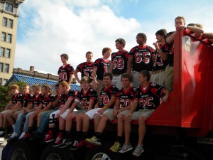 Football players in 2013 homecoming parade