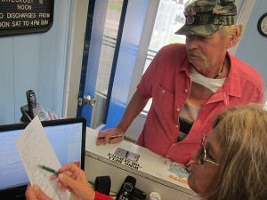 Deb Kern (lower, right) helps a Vietnam war vet fill out paperwork before adopted a pet this past October