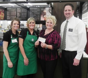 Starbucks and Hy-Vee West employees present a donation in the amount of $3060.50 to Humane Society Director Sybil Soukup; the result of tips collected by the Starbucks baristas.   Pictured are: (L to R)  Starbucks Barista Taylor Chrencik, Starbuck Manager Sheena Murray, Humane Society of North Iowa Executive Director Sybil Soukup, and Hy-Vee West Store Director Mike Winblade.