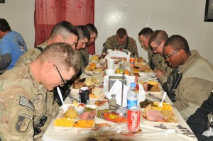 Task Force Lifeliner soldiers bow their heads and give thanks during Thanksgiving Day at the Koele Dining Facility, Nov. 28, 2013, at Bagram Air Field, Parwan province, Afghanistan. The soldiers had the opportunity to celebrate their holiday with a variety of traditional foods. www.facebook.com/lifeliners (U.S. Army photo by Sgt. Sinthia Rosario, Task Force Lifeliner Public Affairs)