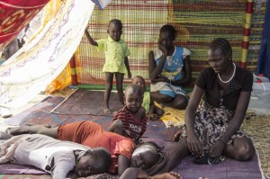 A family of South Sudanese civilians shelter at a UN base in Juba. UNHCR has been taking on increased responsibilities for the 57,000 civilians taking refuge in 10 UN compounds throughout the country. Photo: UNHCR/K. McKinsey