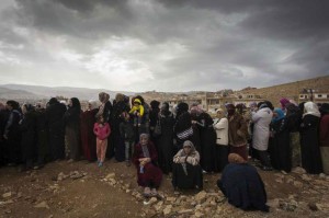 Syrian refugees queue to be registered on the outskirts of the Lebanese town of Arsal. Photo: UNHCR/M. Hofer