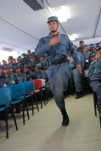 A graduate of Afghan Uniform Police training marches to receive his diploma during a graduation ceremony Aug. 12 in Regional Training Center - Kandahar.