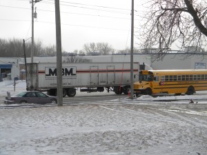 Traffic was reduced to two lanes on 19th Street SW in Mason City Wednesday after a semi driver missed his turn and slid, blocking cars and a school bus