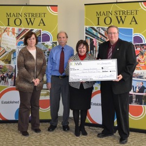 Representatives from Charles City accept a check on January 7, 2014