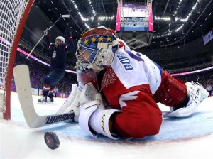 US player reacts to goal as Russian goalie can only watch. (sochi2014.com)