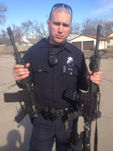 Officer Chris Groth shows difference between toy and real gun (Omaha police social media)