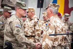 Brig. Gen. James Rainey, deputy commanding general of maneuver, Regional Command (South) and 4th Infantry Division, congratulates Romanian Armed Forces Col. Bixi Mocanu, commander, 12th Detachment, Romanian National Support Element, following a transfer of authority ceremony April 20, 2014, Kandahar Airfield, Afghanistan. The ceremony signified the transfer of mission responsibility, which involves the logistical support of Romanian forces across Afghanistan, from the 12th Det., Romanian National Support Element, to the 13th Det., Romanian NSE. (U.S. Army photo by Sgt. Clay Beyersdorfer)