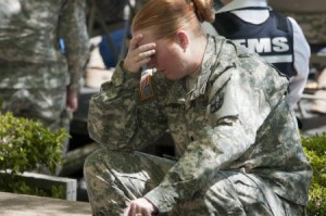 Spc. Patricia Campus, of the 1st Medical Brigade, tries to control her emotions during a memorial service for Sgt. 1st Class Daniel M. Ferguson, Staff Sgt. Carlos A. Lazaney-Rodriguez, and Sgt. Timothy W. Owens, who were killed in the April 2 shooting tragedy on Fort Hood, April 9, 2014. (U.S. Army photo by Sgt. Ken Scar, 7th Mobile Public Affairs Detachment)