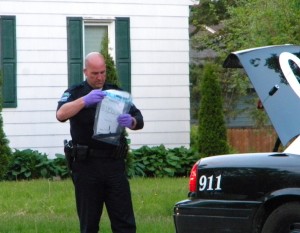Police officer with weapon in evidence bag