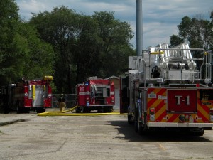 Three Fire Trucks at scene of engulfed building