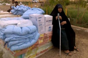 An Iraqi woman displaced by conflict in Anbar rests on a pile of UNHCR mattresses. The aid seen here was distributed shortly afterwards. Photo: UNHCR