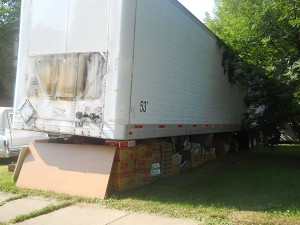 The semi trailer with boxes of "Stuff" underneath
