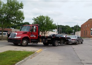7th Street and Federal.  The car fell completely off the flat-bed truck.  Here the tow truck driver has re-attached the car and is driving into the credit union parking lot.