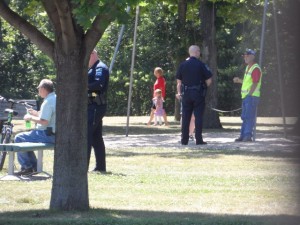 Children look on as police question adults