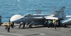 Sailors guide an F/A-18C Hornet assigned to the Valions of Strike Fighter Squadron 15 on the flight deck of the aircraft carrier USS George H.W. Bush, Aug. 8, 2014. The carrier is supporting maritime security operations and theater security cooperation efforts in the U.S. 5th Fleet area of responsibility. U.S. Navy photo by Petty Officer 3rd Class Lorelei Vander Griend  