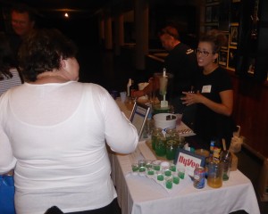 Cassie Peterson of Hy-Vee offers "Lakewater" in the Signature Cocktail Competition held at the Surf Thursday evening