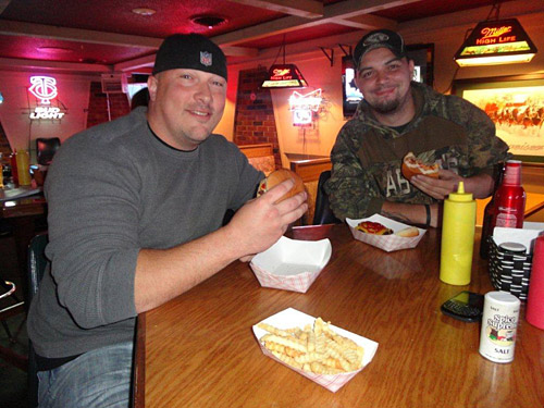 “You can’t get this across the street at McDonald’s,” said Joshua McLaughliin, right, who with friend Matt Bernhardt, left, stopped in for $1 burgers one recent Wednesday evening at Homer's Sports Bar & Grille, 1911 S. Federal Ave.