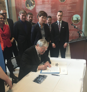 Governor Branstad signs SF2300 as for north Iowa Corridor CEO Brent Willett looks on.