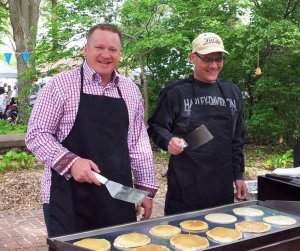 Former political allies Eric Bookmeyer and Scott Tornquist serve free pancakes in 2013